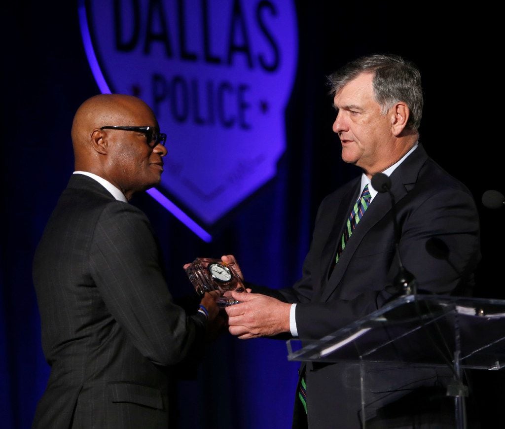 Dallas Mayor Mike Rawlings presents former Dallas Police Chief David Brown with a clock in...