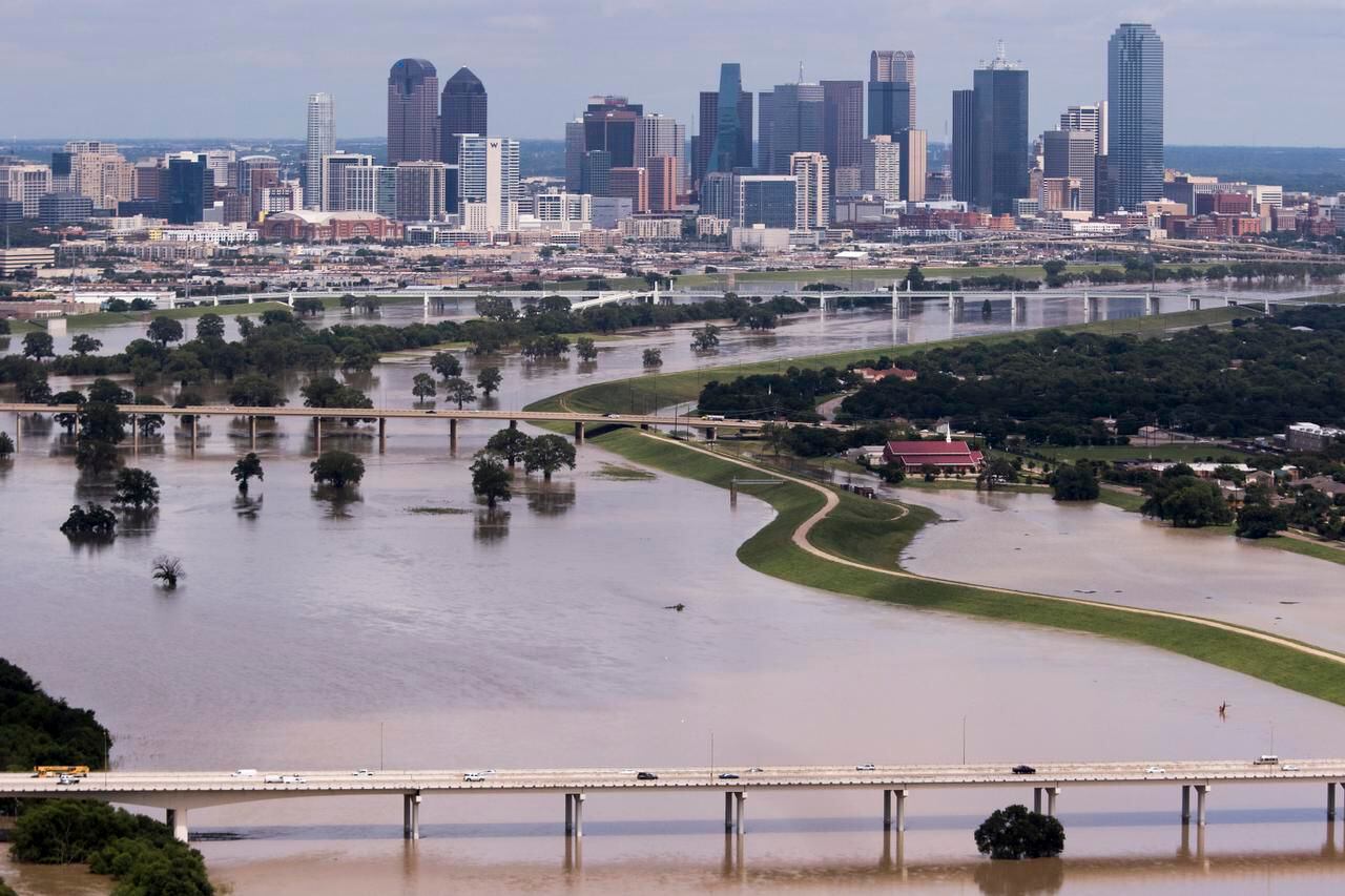 
The swollen Trinity River flowed past downtown Dallas in late May after torrential rains.



