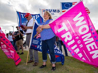 Dolly Stickney holds a 'Woman for Trump' flag during an America is Great rally hosted by...