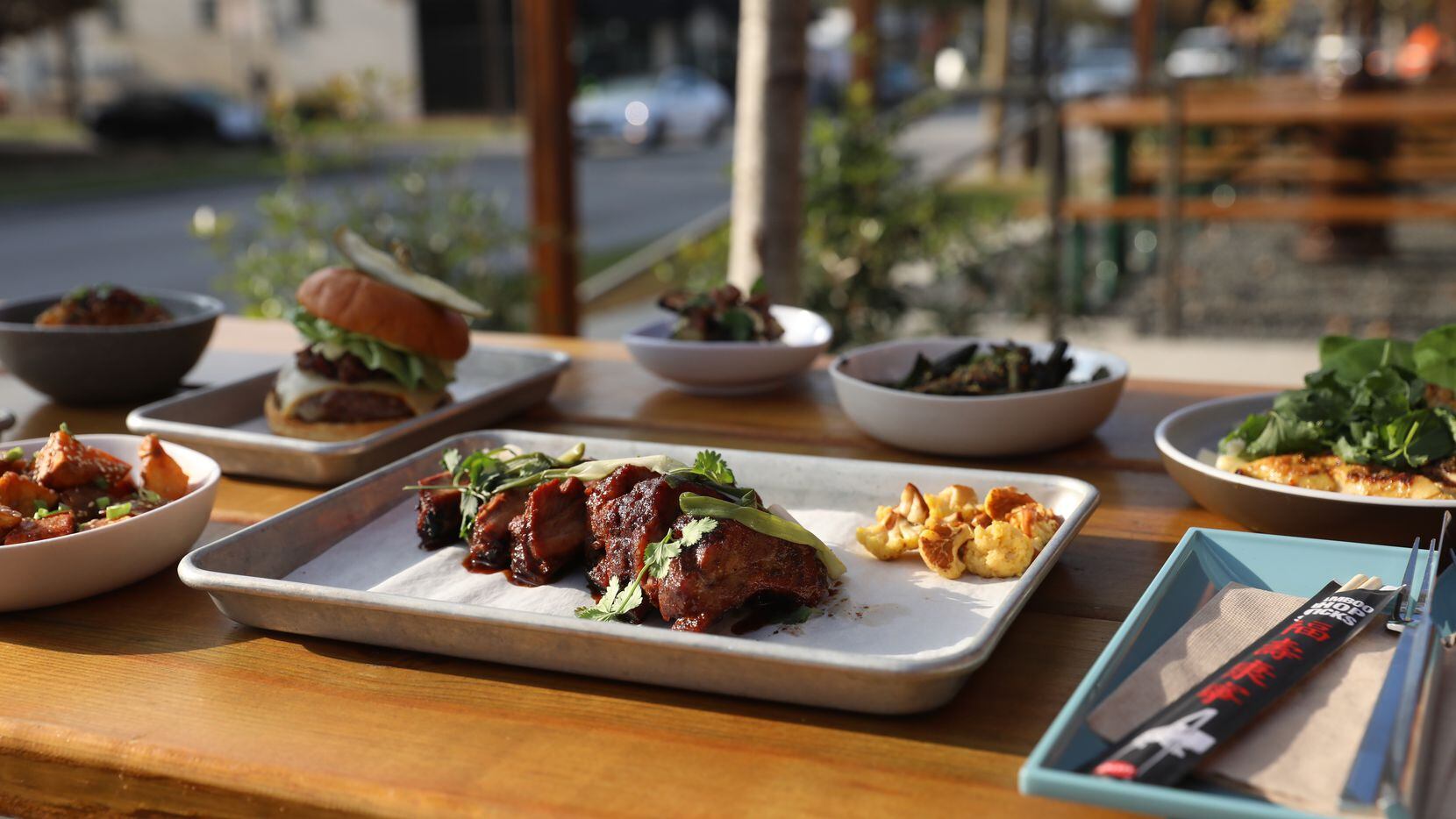 Loro's smoked baby back Duroc pork ribs sit front and center in a spread of the restaurant's...