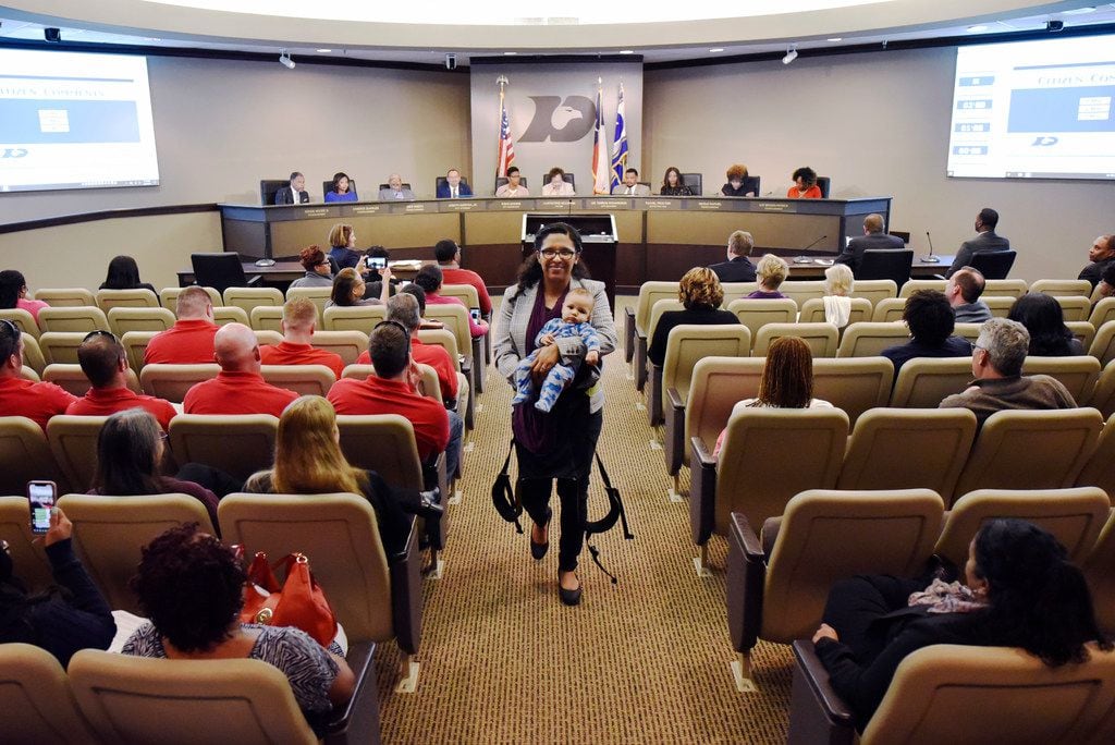 Candace Valenzuela, 34, of Dallas, with her baby Jacinto Baldwin, walks back to her seat...