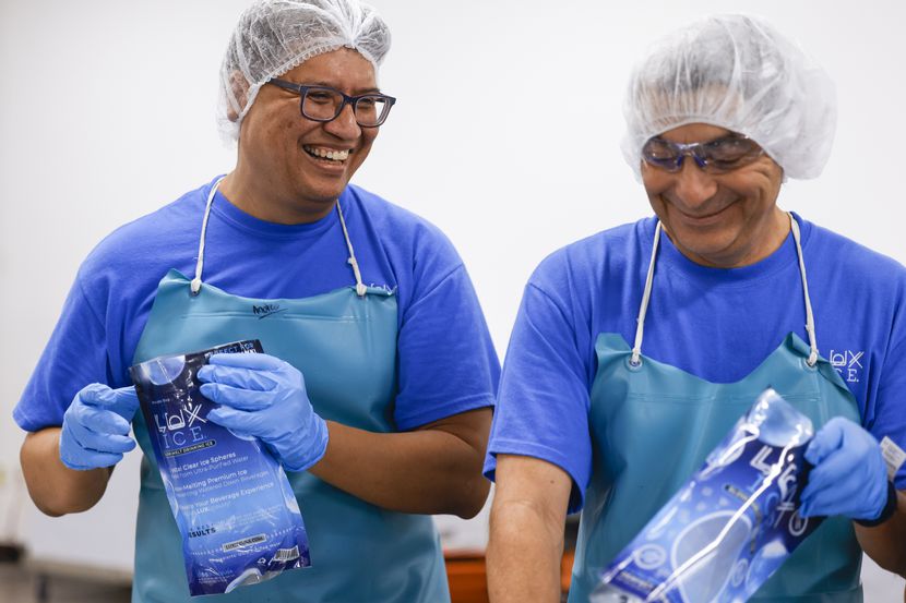 Lux Ice  Andres Tovar (left), smiles towards his coworker Carlos Castillo while packing...