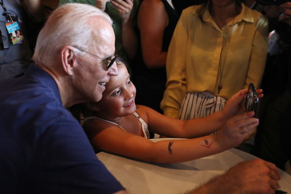 Former Vice President Joe Biden poses for selfies while stumping at the Iowa State Fair on...