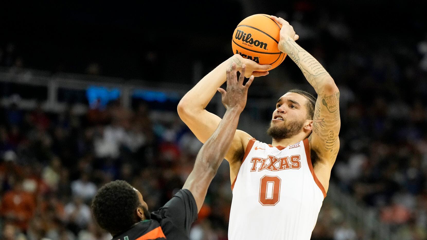 Texas forward Timmy Allen shoots over Miami guard Wooga Poplar in the second half of an...