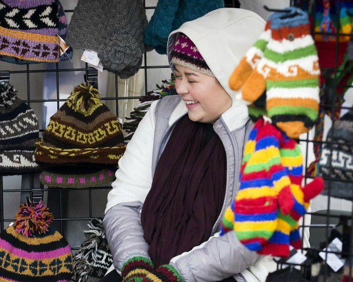 A vendor sells hats and mittens at Home For the Holidays - A McKinney Christmas festival in...