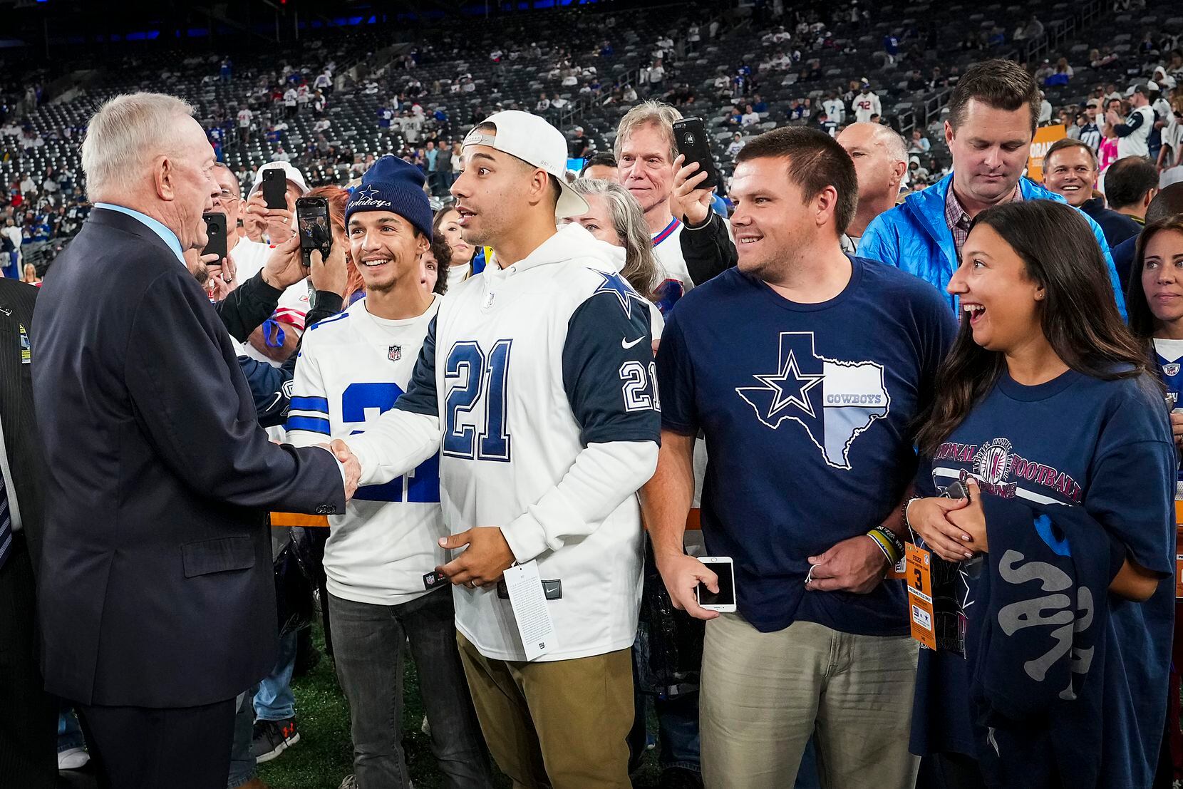 Dallas Cowboys owner and general manager Jerry Jones shakes hands with fans before an NFL...