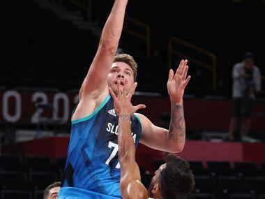 Slovenia’s Luka Doncic (77) attempts a shot in front of Argentina’s Facundo Campazzo (7) in...