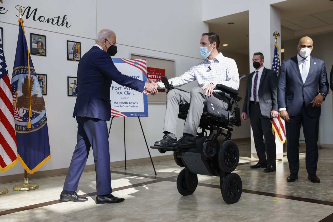 President Joe Biden greets lead physical therapist Josh Geering after demonstrating the...