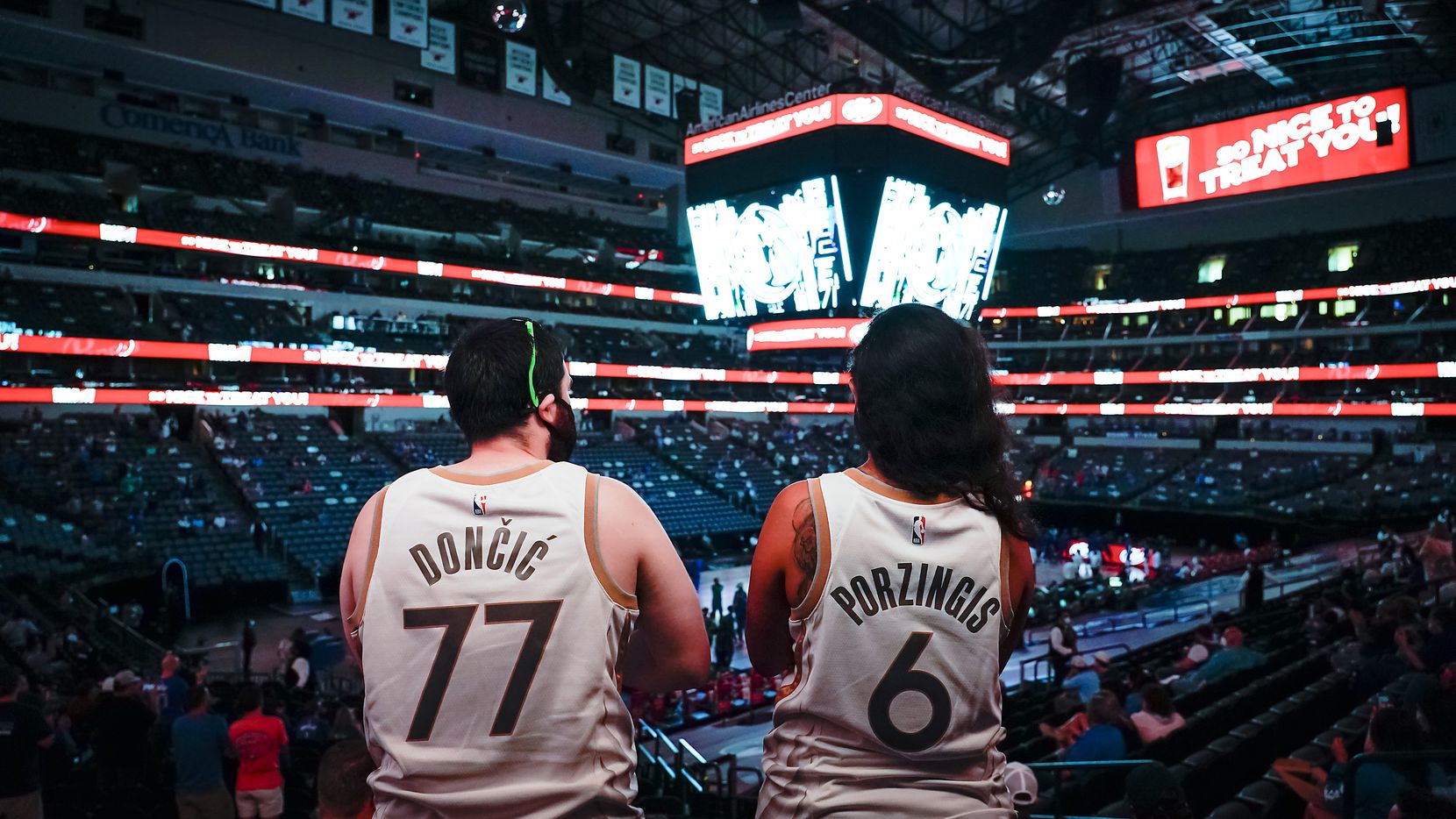 Fans wearing the jerseys of Dallas Mavericks guard Luka Doncic and Kristaps Porzingis cheer as the tea is announced before an NBA basketball game against the Sacramento Kings at American Airlines Center on Sunday, May 2, 2021, in Dallas.