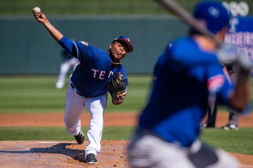 Texas Rangers pitcher Edinson Volquez pitches during the first inning of a spring training...