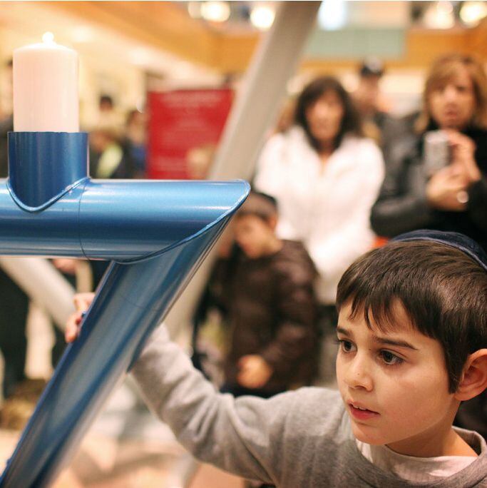 Menachem Lewin atends the lighting of the community menorah at the Galleria.