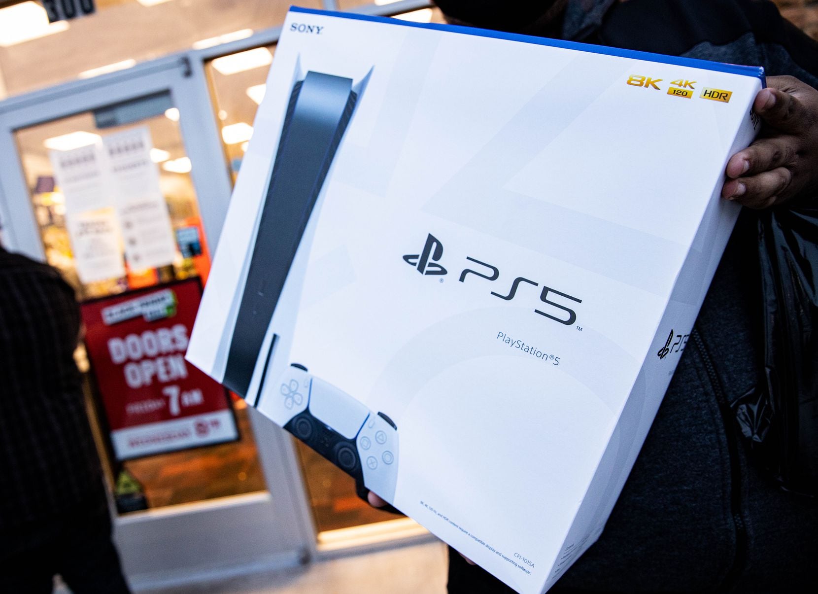 Irving's Brandon Lopez is holding the PlayStation 5 he bought after standing in line for 10 a.m. on Thanksgiving Day.