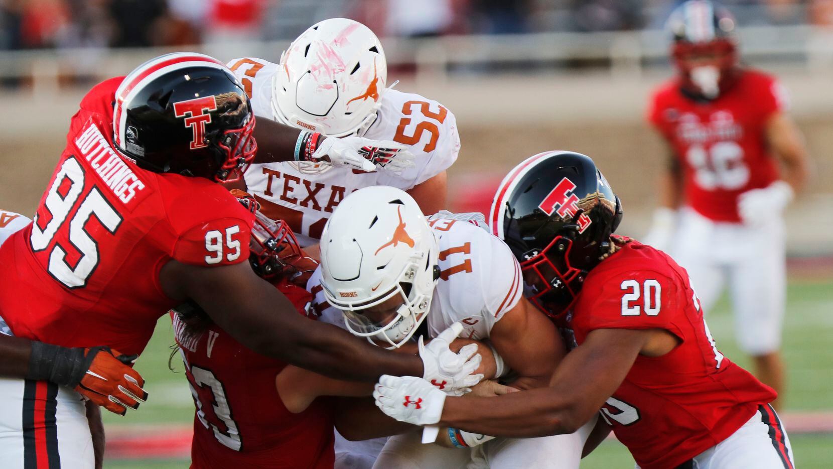Texas Tech defensive lineman Jaylon Hutchings and linebacker Kosi Eldridge tackle Texas...