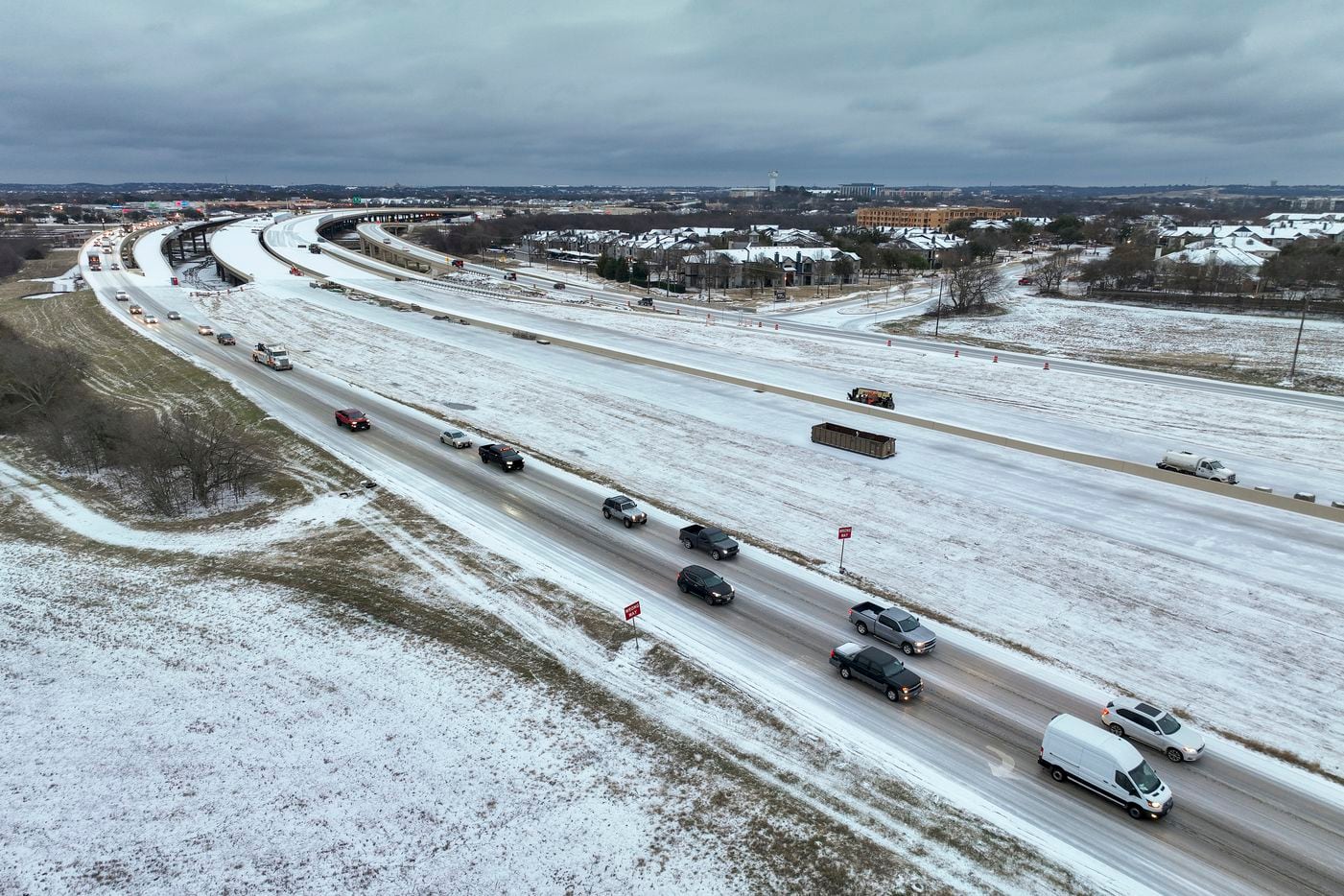 An icy mix covers Texas 114 on Monday, Jan. 30, 2023, in Roanoke. Dallas and other parts of...