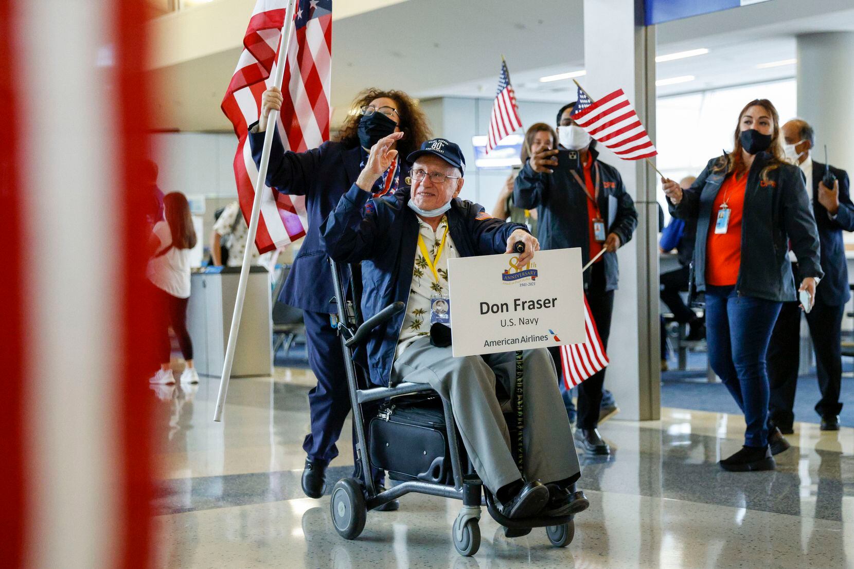 Fraser saluted onlookers during a sendoff to Hawaii at DFW International Airport on Friday, Dec. 3, 2021.