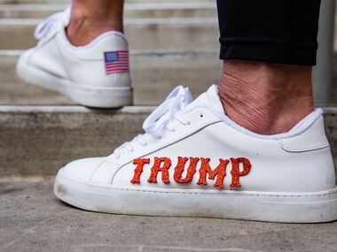 Heather Salazar from McKinney wears shoes with Trump's name during an America is Great rally...