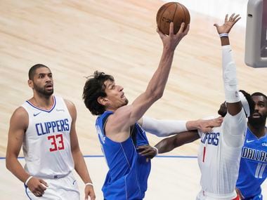 Dallas Mavericks center Boban Marjanovic (51) scores past LA Clippers guard Reggie Jackson (1) during the first quarter of an NBA playoff basketball game at the American Airlines Center on Friday, June 4, 2021, in Dallas.