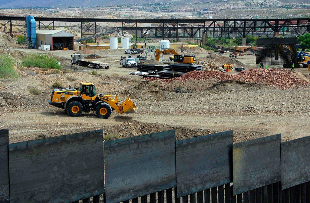 Workers build a section of border fence on private property in Sunland Park, N.M.