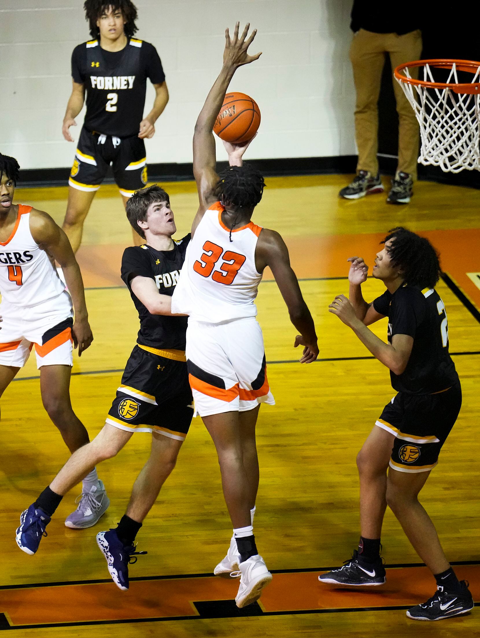 Forney guard Ayden McDonald (5) has his shot blocked by Lancaster's Amari Reed (33) during a...
