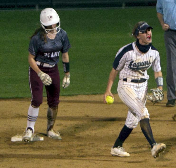 Flower Mound shortstop McKenna Andrews (6), right, lets out a yell after tagging out Plano...