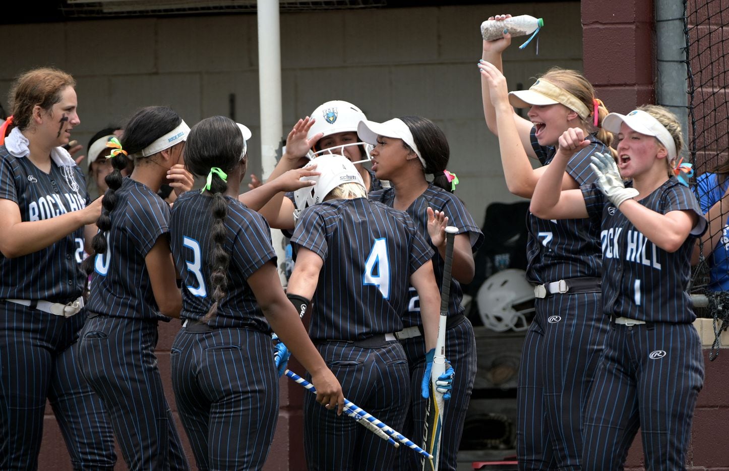 Prosper Rock Hill's Leah Rinehart (4) is congratulated by teammates after scoring a run in...