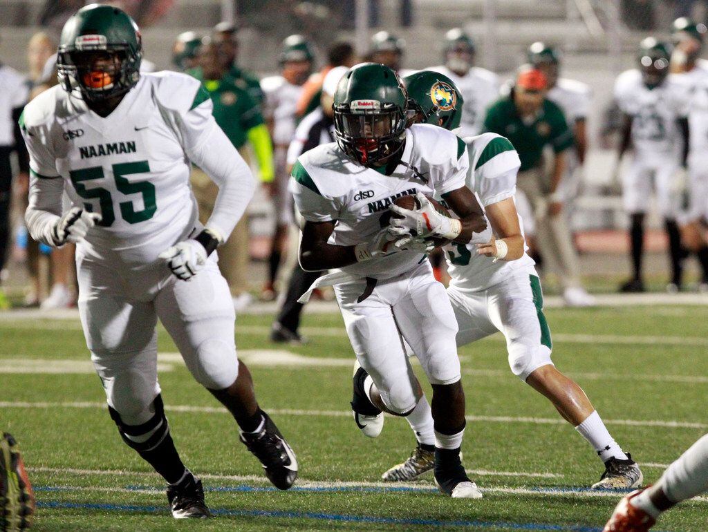 Naaman Forest RB Kingsley Bennett (2) picks up a couple of yards during the first half of...