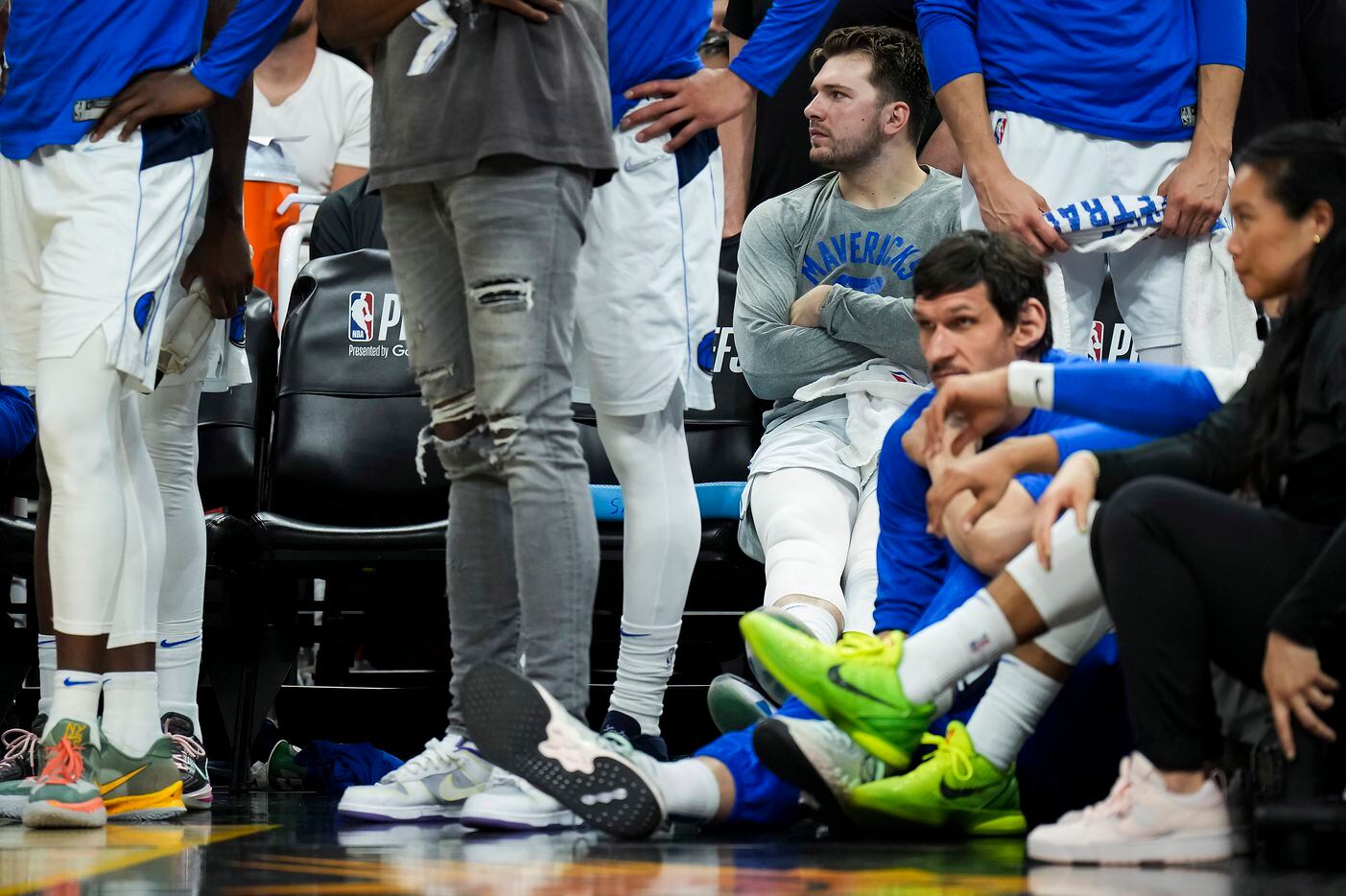 Dallas Mavericks guard Luka Doncic (77) watches from the bench during the fourth quarter in...