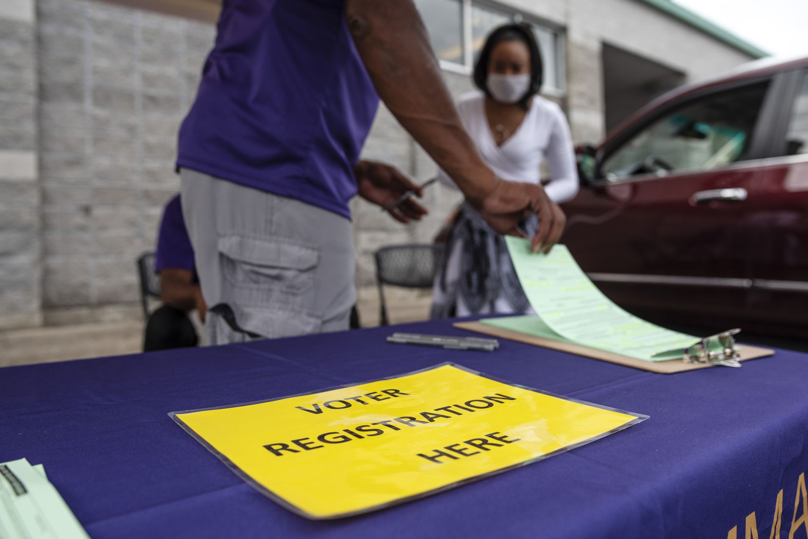 Omega Psi Phi Fraternity, INC, part of the National Pan-Hellenic Council, conducts a voter registration drive outside of the Cash Saver grocery store in south Dallas, Saturday, Sept. 05, 2020.