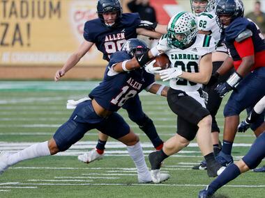 Allen’s Malakai Thornton (18) is called for a facemask penalty against Southlake Carroll’s...