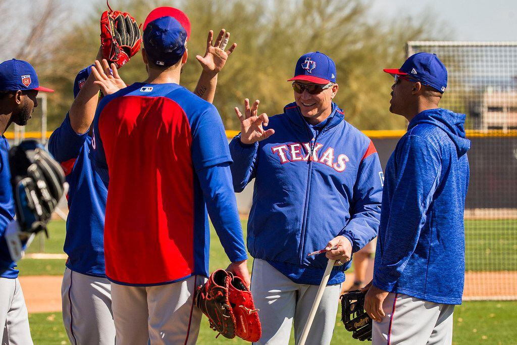 Texas Rangers manager Jeff Banister (facing) laugh with (from left) infielder Jurickson...
