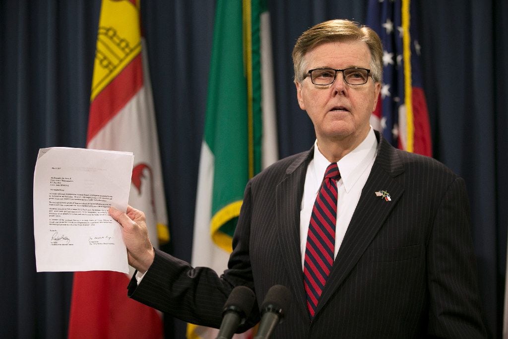 Lt. Gov. Dan Patrick holds up a letter in support of real estate tax relief during a news...