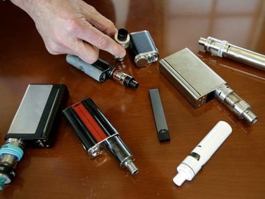 In this April 10, 2018, file photo, a high school principal displays vaping devices that...