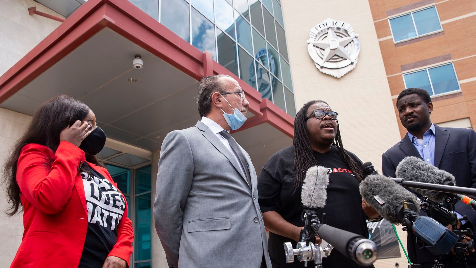 Dallas Police Oversight Coalition leader Changa Higgins (third from left) speaks along with...