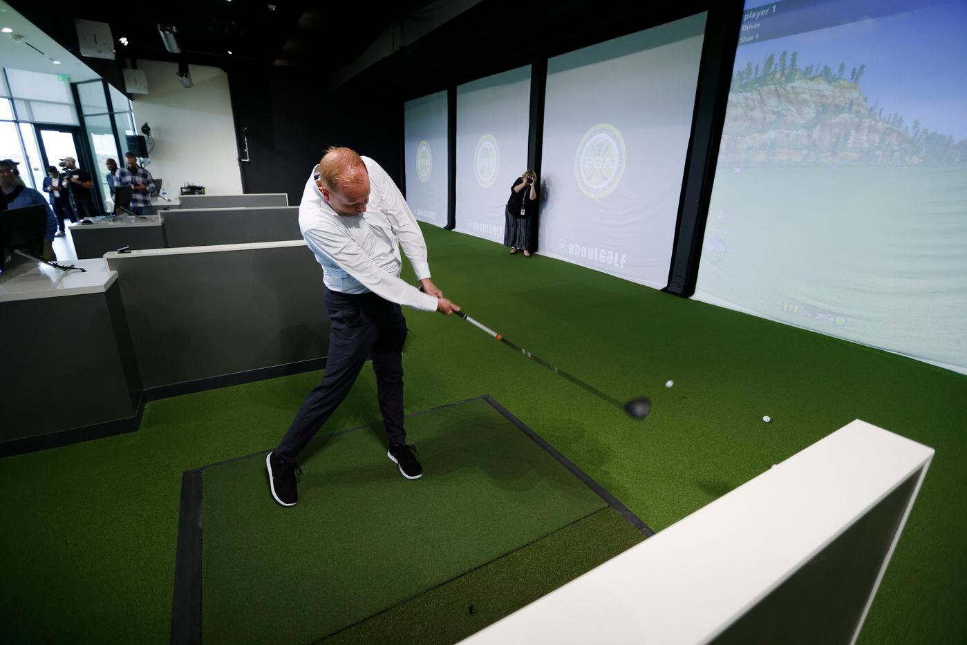 Jeff Cheney, mayor of Frisco hits a golf ball inside the new PGA of America headquarters...