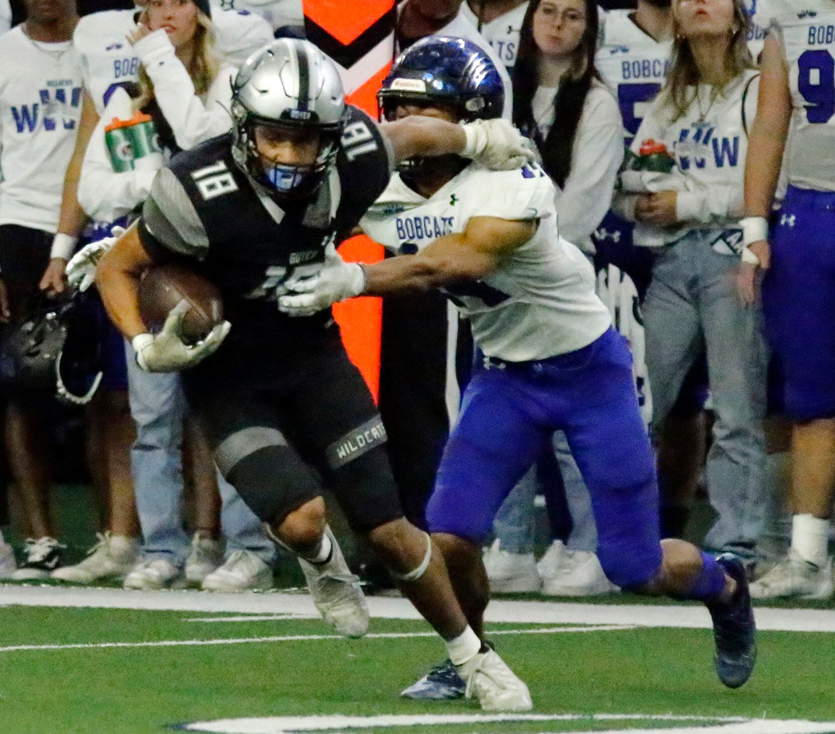 Guyer High School cornerback Eli Bowen (18) tries to break away from Byron Nelson High School wide receiver Landon Ransom (14) after Bowen made an interception during the first half as Denton Guyer High School played Trophy Club Byron Nelson High School in a Class 6A Division II Region I semifinal football game at The Ford Center in Frisco on Saturday, November 27, 2021. (Stewart F. House/Special Contributor)