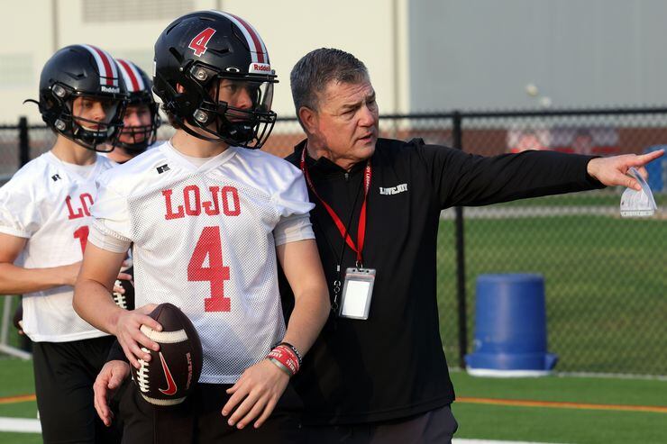 Lucas Lovejoy head coach Todd Dodge directs quarterback Jacob Janecek (4) to the details of...