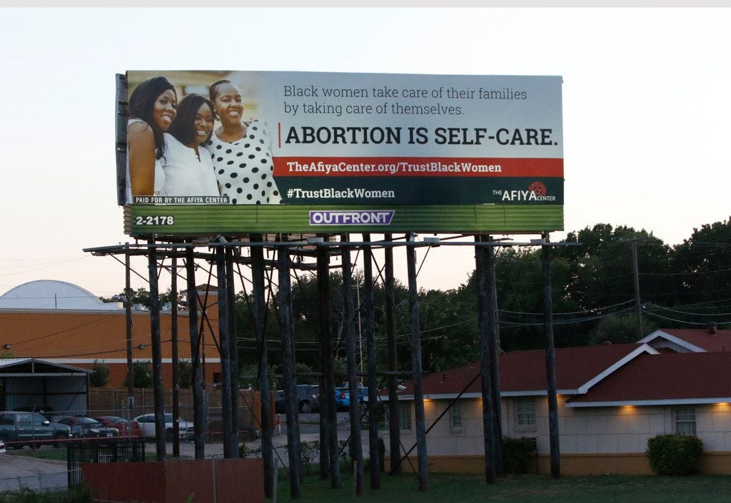 
A billboard from the Dallas-based Afiya Center proclaims "abortion is self-care" and...