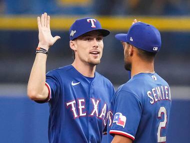Texas Rangers left fielder Evan Carter (32) celebrates with second baseman Marcus Semien (2)...