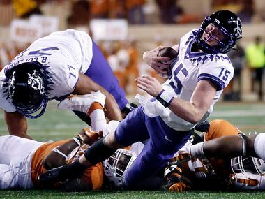 TCU Horned Frogs quarterback Max Duggan (15) is tackled in the open field by a pair of Texas...