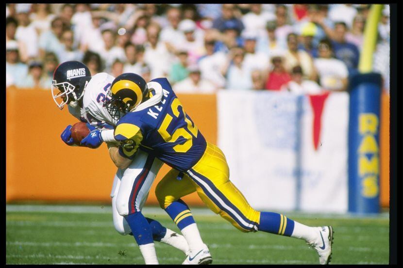 12 Nov 1989: Linebacker Larry Kelm of the Los Angeles Rams tackles New York Giants running...
