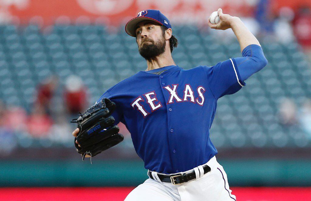 Texas Rangers starting pitcher Cole Hamels throws during the first inning of an exhibition...