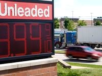 The price of regular unleaded gas is advertised for just under $4 a gallon at a Woodman's,...