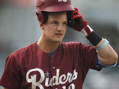 Frisco RoughRiders 3rd baseman Josh Jung (18) puts on his batting helmet as he heads to the on-deck circle during the bottom of the first inning of play against San Antonio. The two teams played their minor league baseball game at Riders Field in Frisco on June 22, 2021 (Steve Hamm/ Special Contributor)