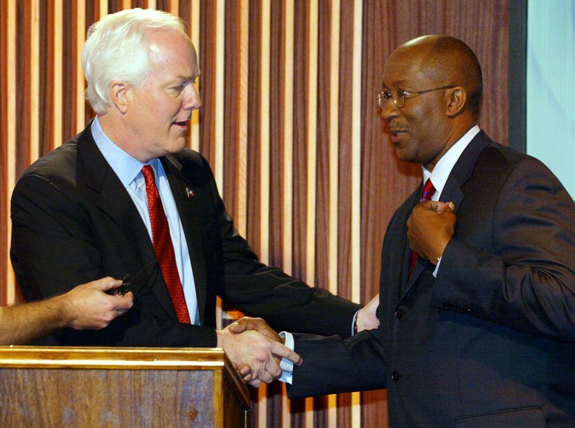 Democrat Ron Kirk, right, and Republican John Cornyn shake hands before a U.S. Senate debate...