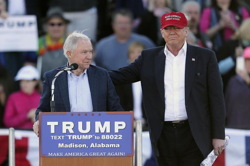 
Republican presidential candidate Donald Trump, right, stands next to Sen. Jeff Sessions,...