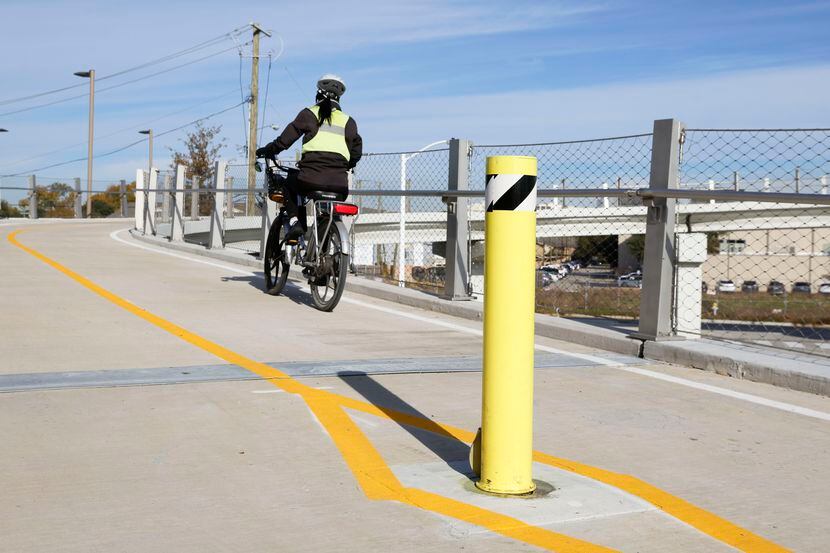 A bicyclist goes up the ramp of Northaven Trail pedestrian bridge on Wednesday, Nov. 29,...