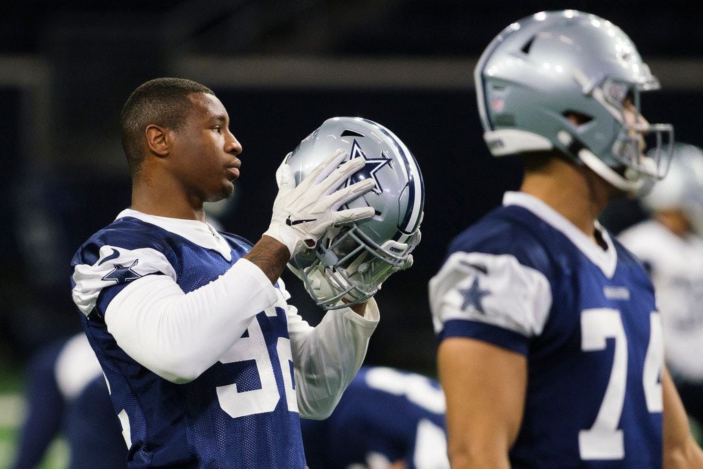 Dallas Cowboys defensive end Dorance Armstrong (92) puts on his helmet during a team OTA...