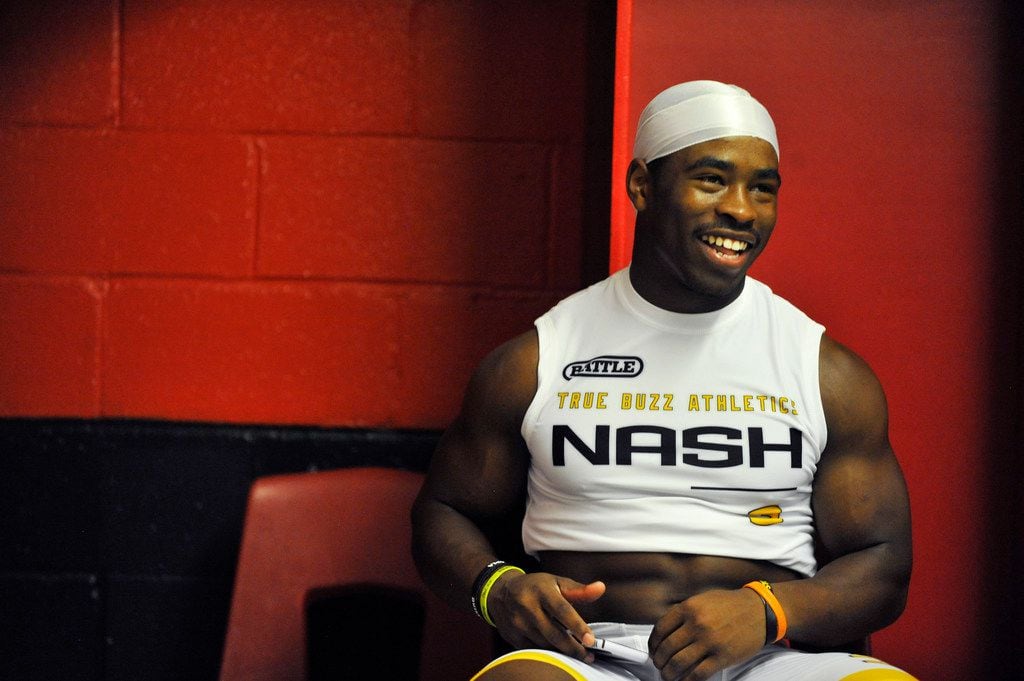 True Buzz running back Myles Nash laughs with his teammates in the locker room prior to the...