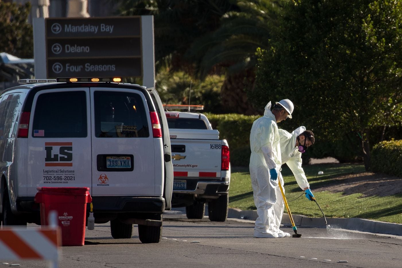 LAS VEGAS, NV - OCTOBER 3: Hazardous material clean-up workers scrub the street on Las Vegas...
