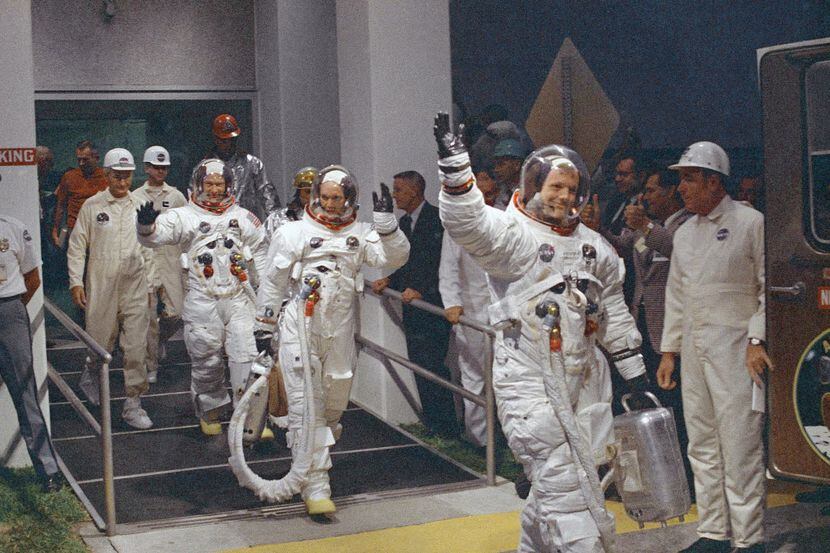 In this July 16, 1969 file photo, Neil Armstrong waving in front, heads for the van that...
